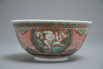 A Chinese wucai bowl with boys holding lotus flowers, Transitional period