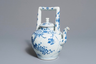 A Chinese blue and white wine jug and cover with fine design of birds and prunus branches, Transitional period