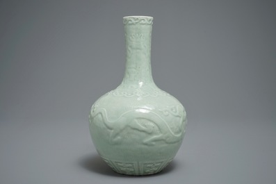 Un vase de forme bouteille en porcelaine de Chine c&eacute;ladon &agrave; d&eacute;cor en relief, marque de Qianlong, 19/20&egrave;me