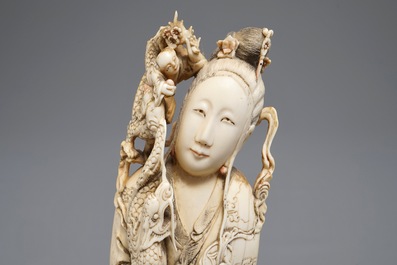 A Chinese carved ivory figure of an immortal with mythical beasts, 19th C.