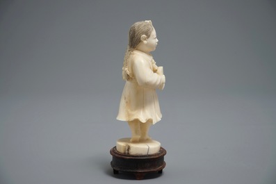 A Chinese carved ivory model of a girl, 1st half 20th C.