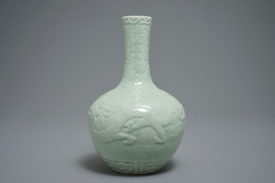 A Chinese bottle-shaped celadon vase with applied design, Qianlong mark, 19/20th C.