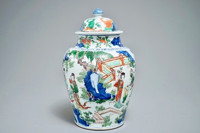 A Chinese wucai baluster vase and cover with figures in a landscape, Transitional period