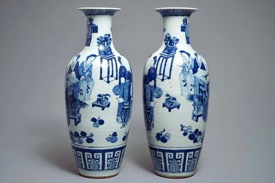 A pair of Chinese blue and white vases with ladies at a table, 19th C.