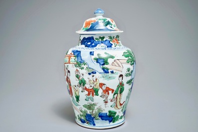 A Chinese wucai baluster vase and cover with figures in a landscape, Transitional period