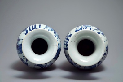 A pair of Chinese blue and white vases with ladies at a table, 19th C.