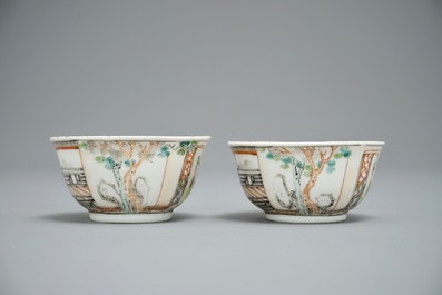 A pair of fine Chinese famille rose cups and saucers with figures in a garden, Yongzheng/Qianlong