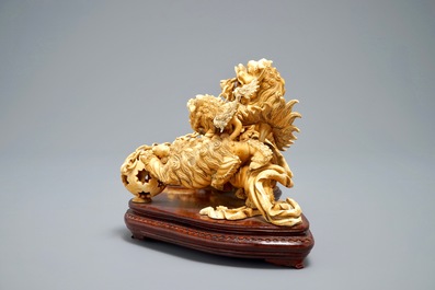 A Chinese carved ivory group of Buddhist lions playing with a ball, 19/20th C.