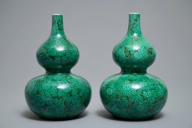 A pair of Chinese double gourd green-ground vases with squash fruit and vines, Republic, 20th C.