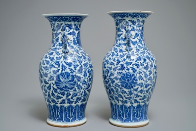 A pair of Chinese blue and white flower scroll vases, 19th C.