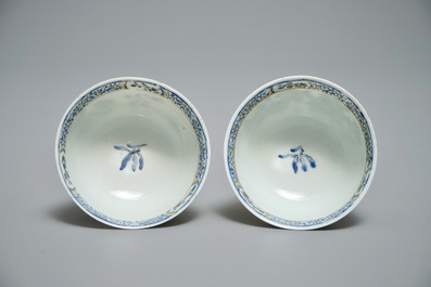 A pair of Chinese eggshell cups and saucers with overglaze blue and gilt floral design, Yongzheng