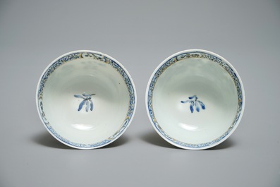 A pair of Chinese eggshell cups and saucers with overglaze blue and gilt floral design, Yongzheng