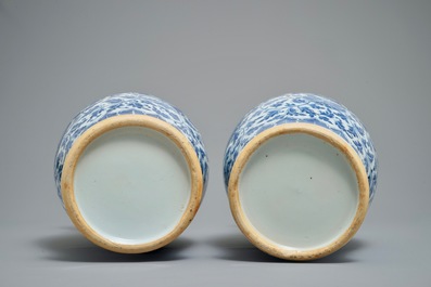 A pair of Chinese blue and white flower scroll vases, 19th C.