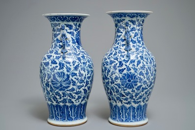 A pair of Chinese blue and white flower scroll vases, 19th C.