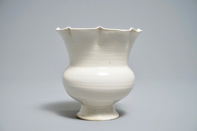 A Chinese foliate-rimmed cream-glazed dingyao bowl on foot, Song or later