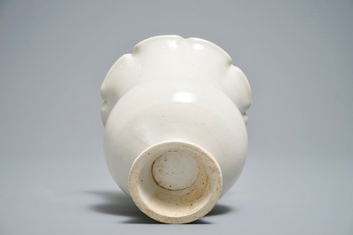 A Chinese foliate-rimmed cream-glazed dingyao bowl on foot, Song or later