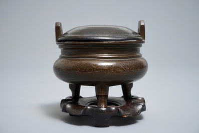 A Chinese silver-inlaid bronze incense burner on stand, 19th C.