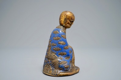 A Chinese champlev&eacute; enamel and gilt copper model of a Luohan, Qianlong