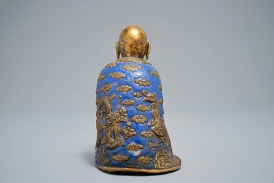 A Chinese champlev&eacute; enamel and gilt copper model of a Luohan, Qianlong