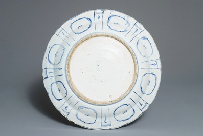 A large Chinese blue and white kraak porcelain dish with an arrangement of vases, Wanli