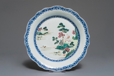 Four Chinese famille rose plates and a charger with landscape designs, Qianlong