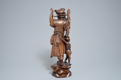 A tall Chinese silver-inlaid wooden figure of Zhong Kui, 19th C.