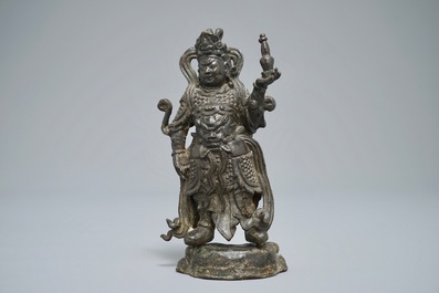 A Chinese bronze figure of the guardian king Dhanada, Ming