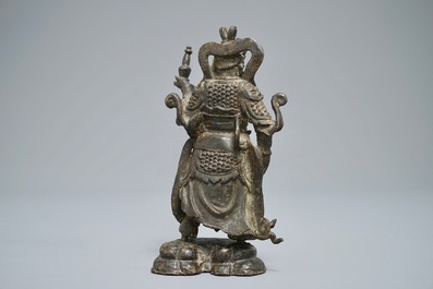 A Chinese bronze figure of the guardian king Dhanada, Ming