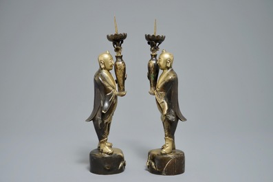 A pair of Chinese bronze 'Hehe Er Xian brothers' candlesticks, 19/20th C.
