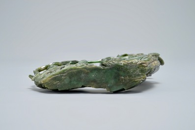 A Chinese spinach green jade group of Guanyin with a child, 19th C.