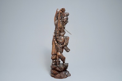 A tall Chinese silver-inlaid wooden figure of Zhong Kui, 19th C.