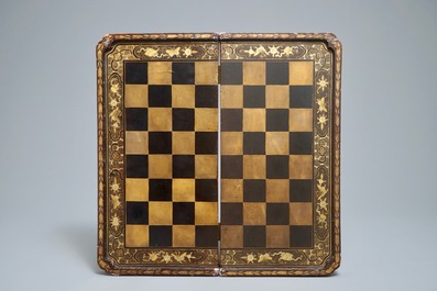 A Chinese lacquered chess and backgammon board with ivory chessmen, 19th C.