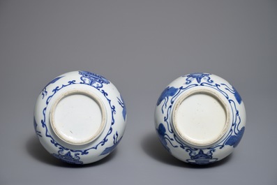 A pair of Chinese blue and white bottle vases with ribbons and precious objects, Kangxi