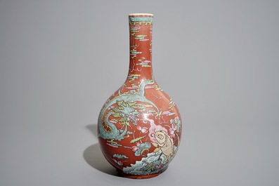 A Chinese oxblood-glazed bottle vase with overglaze design of a dragon and a carp, 19th C.