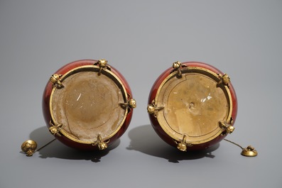 A pair of Chinese gilt bronze-mounted oxblood-glazed vases, 19th C.