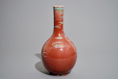 A Chinese oxblood-glazed bottle vase with overglaze design of a dragon and a carp, 19th C.