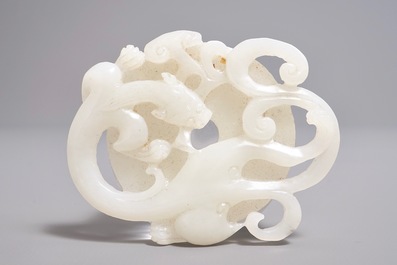 A Chinese white jade carving of a dragon on a bi-disc, 20th C.