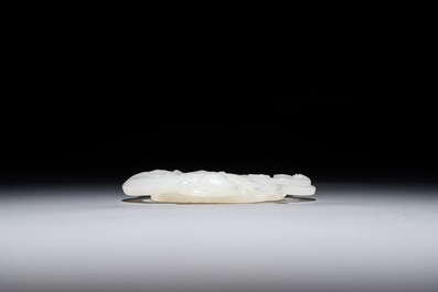A Chinese white jade carving of a dragon on a bi-disc, 20th C.