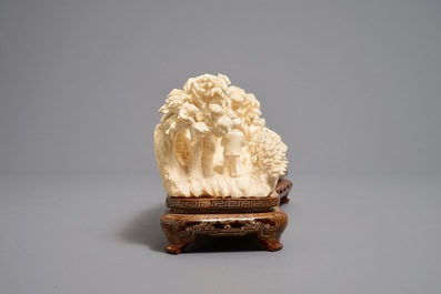 A Chinese carved ivory group of a village scene, 1st half 20th C.