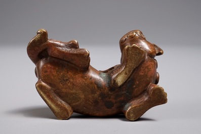 A Chinese bronze scroll or paper weight shaped as a Buddhist lion or Shishi, 17/18th C.