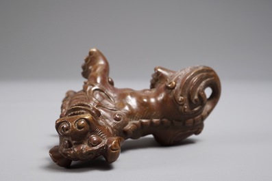 A Chinese bronze scroll or paper weight shaped as a Buddhist lion or Shishi, 18/19th C.