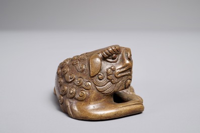 A Chinese bronze scroll or paper weight shaped as a Buddhist lion or Shishi, 17/18th C.