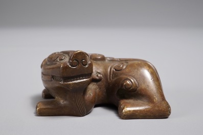 A Chinese bronze scroll or paper weight shaped as a Buddhist lion or Shishi, 18/19th C.