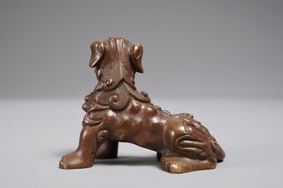 A Chinese bronze scroll or paper weight shaped as a Buddhist lion or Shishi, 18/19th C.