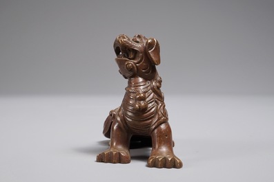 A Chinese bronze scroll or paper weight shaped as a Buddhist lion or Shishi, 18/19th C.