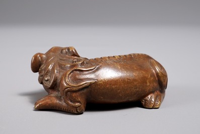 A Chinese bronze scroll or paper weight shaped as a Buddhist lion or Shishi, 17/18th C.