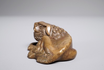 A Chinese bronze scroll or paper weight shaped as a Buddhist lion or Shishi, 17/18th C.