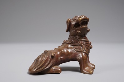 A Chinese bronze scroll or paper weight shaped as a Buddhist lion or Shishi, 18/19th C.