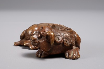 A Chinese bronze scroll or paper weight shaped as a Buddhist lion or Shishi, 17/18th C.