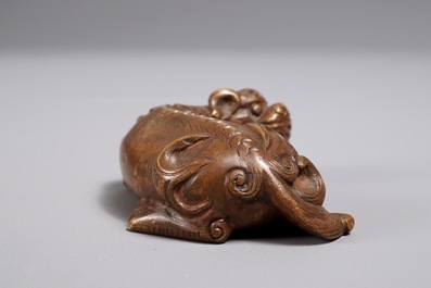 A Chinese bronze scroll or paper weight shaped as a Buddhist lion or Shishi, 17/18th C.